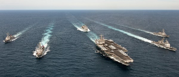 Multiple Navy ships in ocean